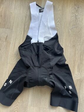 Pas Normal Studios Men’s Black Cycling Bib Shorts with White Straps